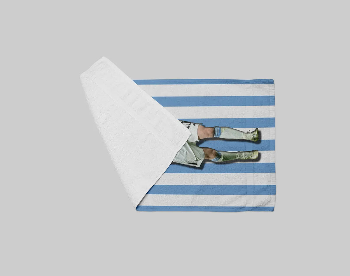 Striped towel with a person in a swimsuit on a gray background