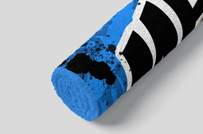 Blue foam roller with black and white design on a gray background