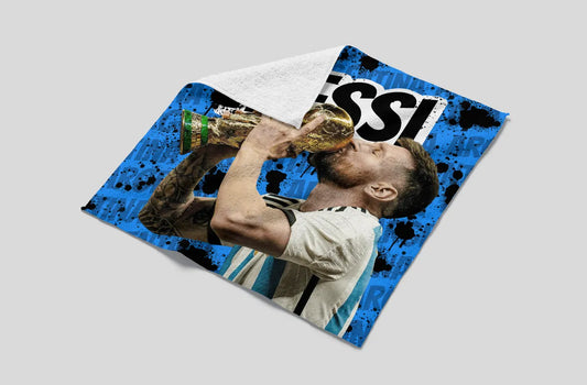 Towel with a sports player design and 'Messi' branding on a gray background