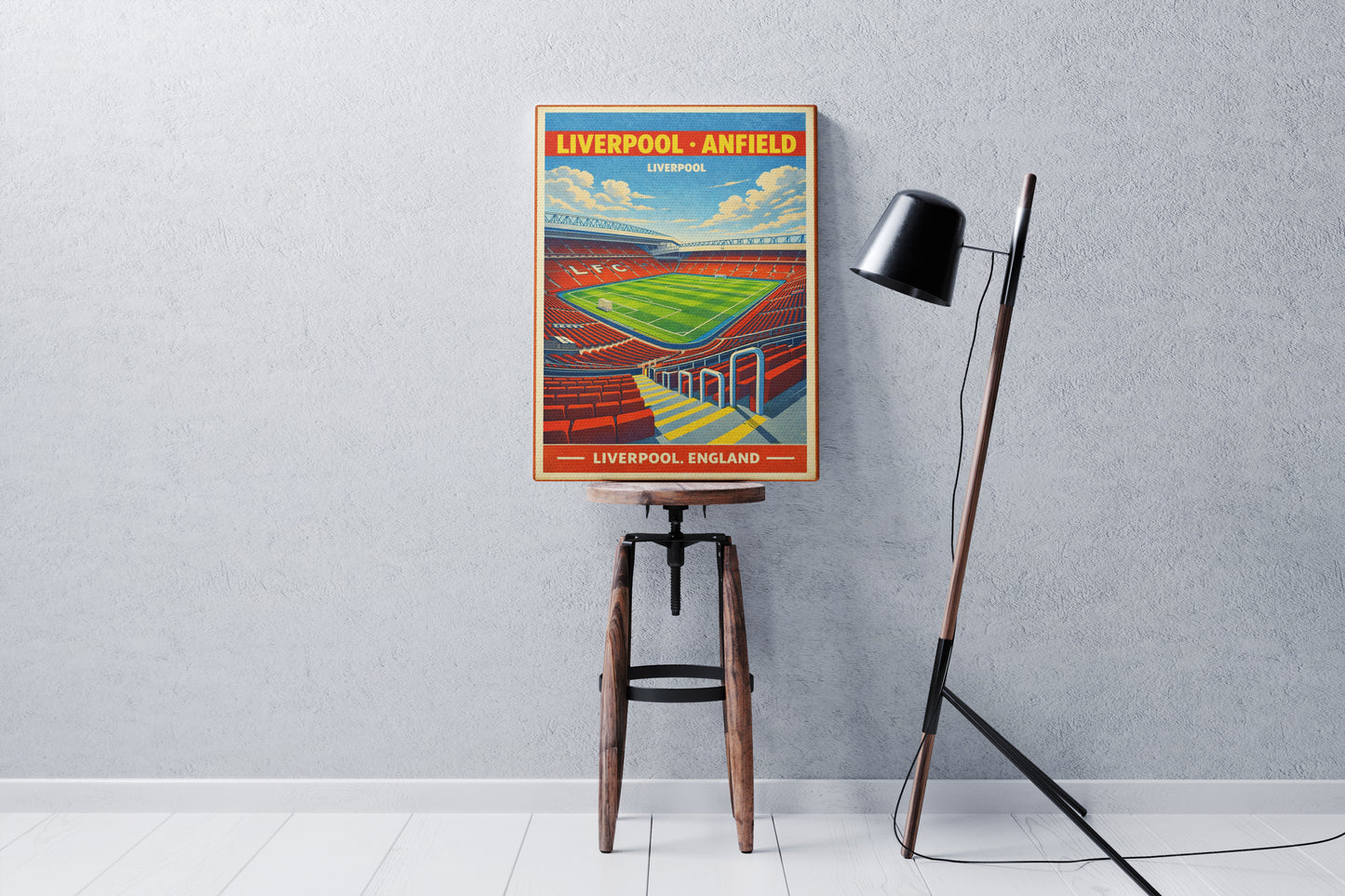 Poster of Liverpool Anfield stadium on a stool against a gray wall.