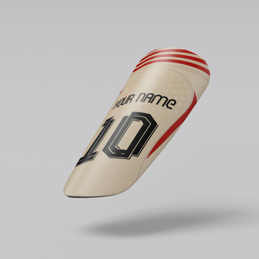 Beige cricket bat with red and black design on a gray background