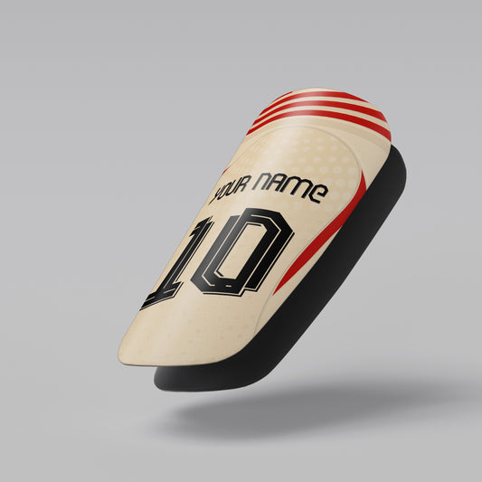 Beige cricket bat with red and black design on a gray background