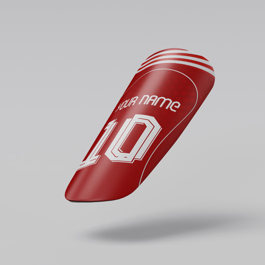 Red shin guard with customizable text on a gray background