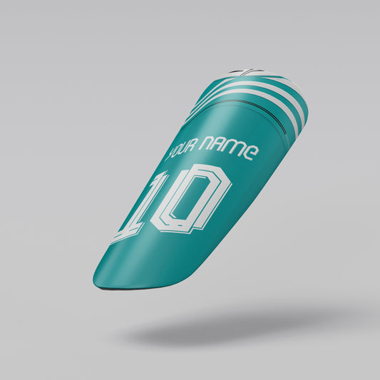 Teal shin guard with white text and numbering on a gray background