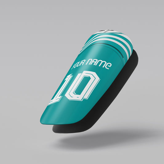 Teal shin guard with customizable text on a gray background