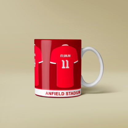Red mug with a football jersey design featuring 'Anfield Stadium' on a beige background