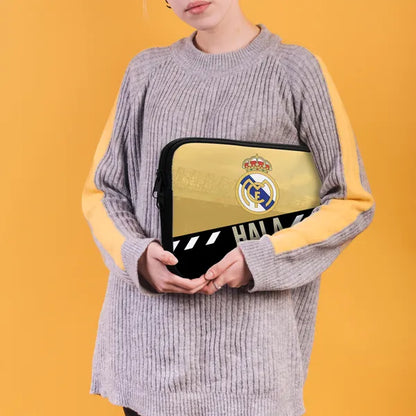 Person holding a laptop case with a logo against an orange background