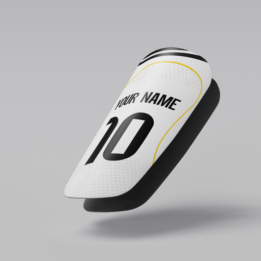 White soccer shin guard with customizable text on a gray background