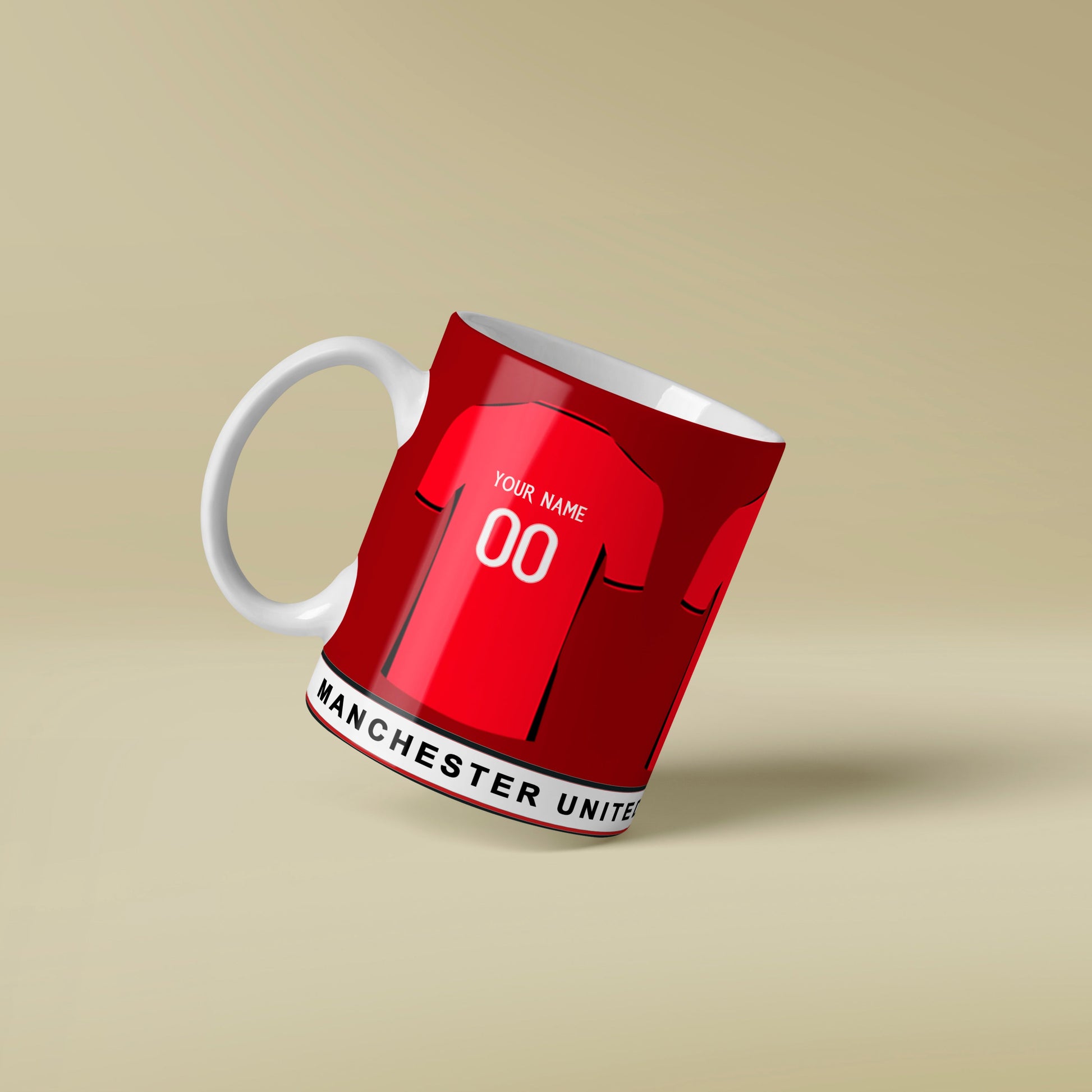 Red mug with white handle featuring Man United design on a beige background