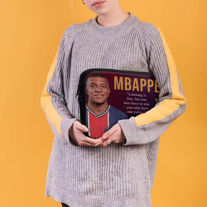 Person holding a pouch with a portrait and text on a yellow background