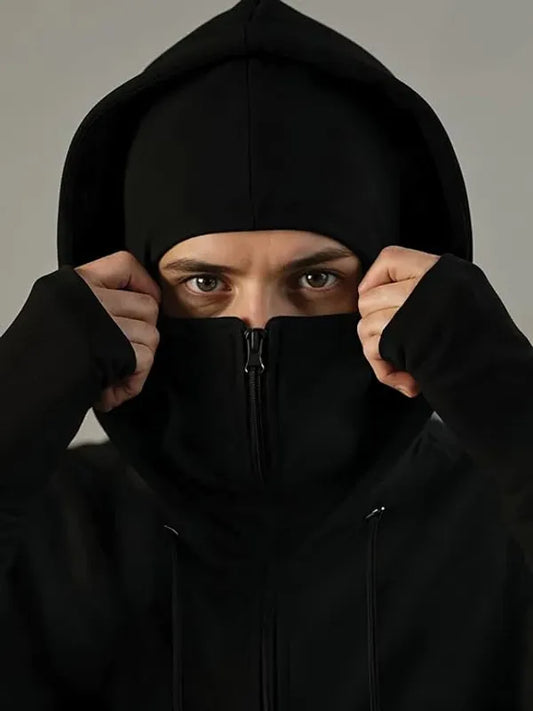 Person wearing a black hoodie with the hood up, obscuring their face.
