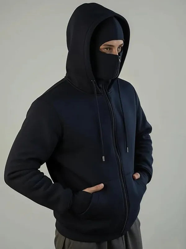 Person wearing a black hoodie with a plain background