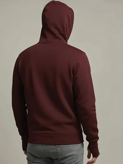 Maroon hoodie worn by a person on a beige background