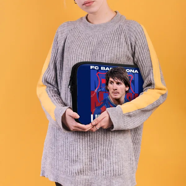 Person holding a blue pouch with FC Barcelona branding against a yellow background