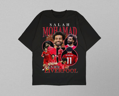 Black t-shirt with soccer player graphics and text on a gray background