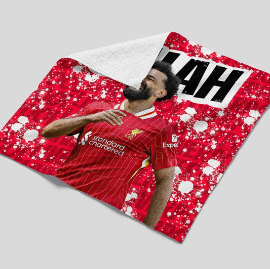 Person wearing a red sports jersey with visible branding on a gray background