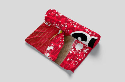 Red fabric with a pattern and a logo on a gray background