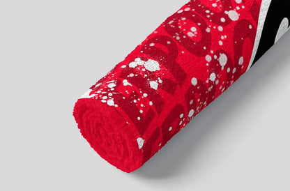 Red patterned fabric roll on a gray background