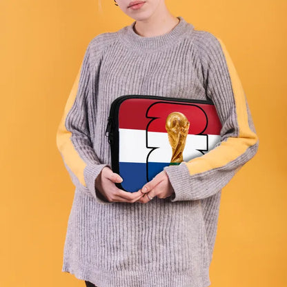 Person holding a pouch with a design of a trophy and flag on an orange background