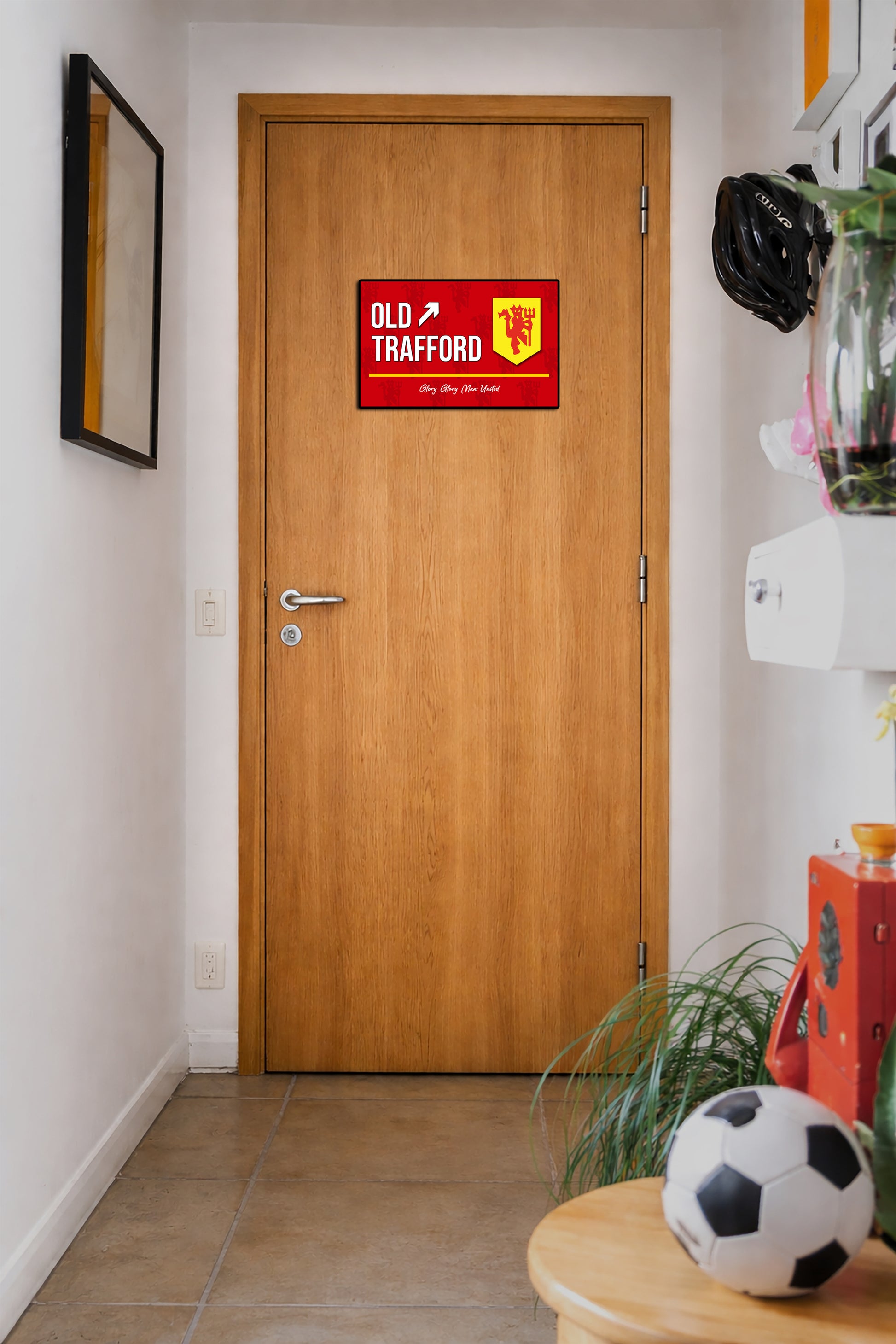 Wooden door with Old Trafford sign in a hallway