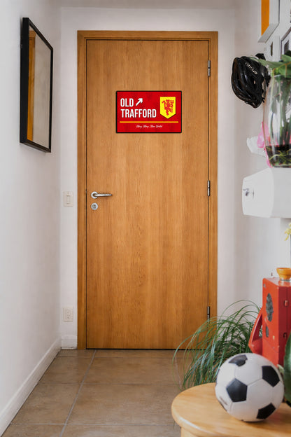Wooden door with Old Trafford sign in a hallway