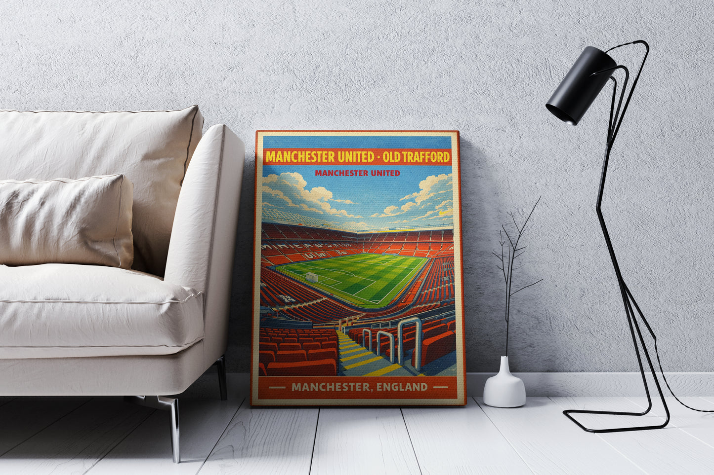 Framed poster of a stadium in a living room setting with a sofa and lamp.