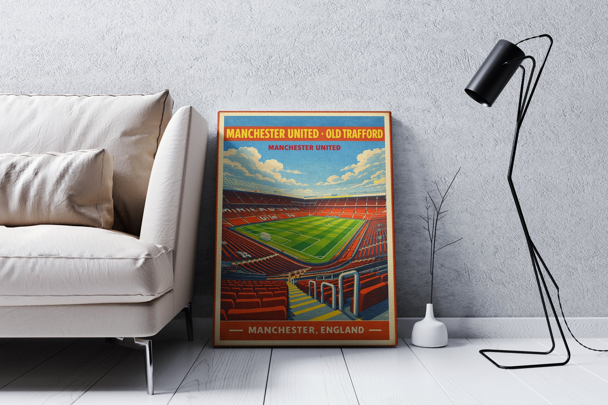 Framed poster of a stadium in a living room setting with a sofa and lamp.