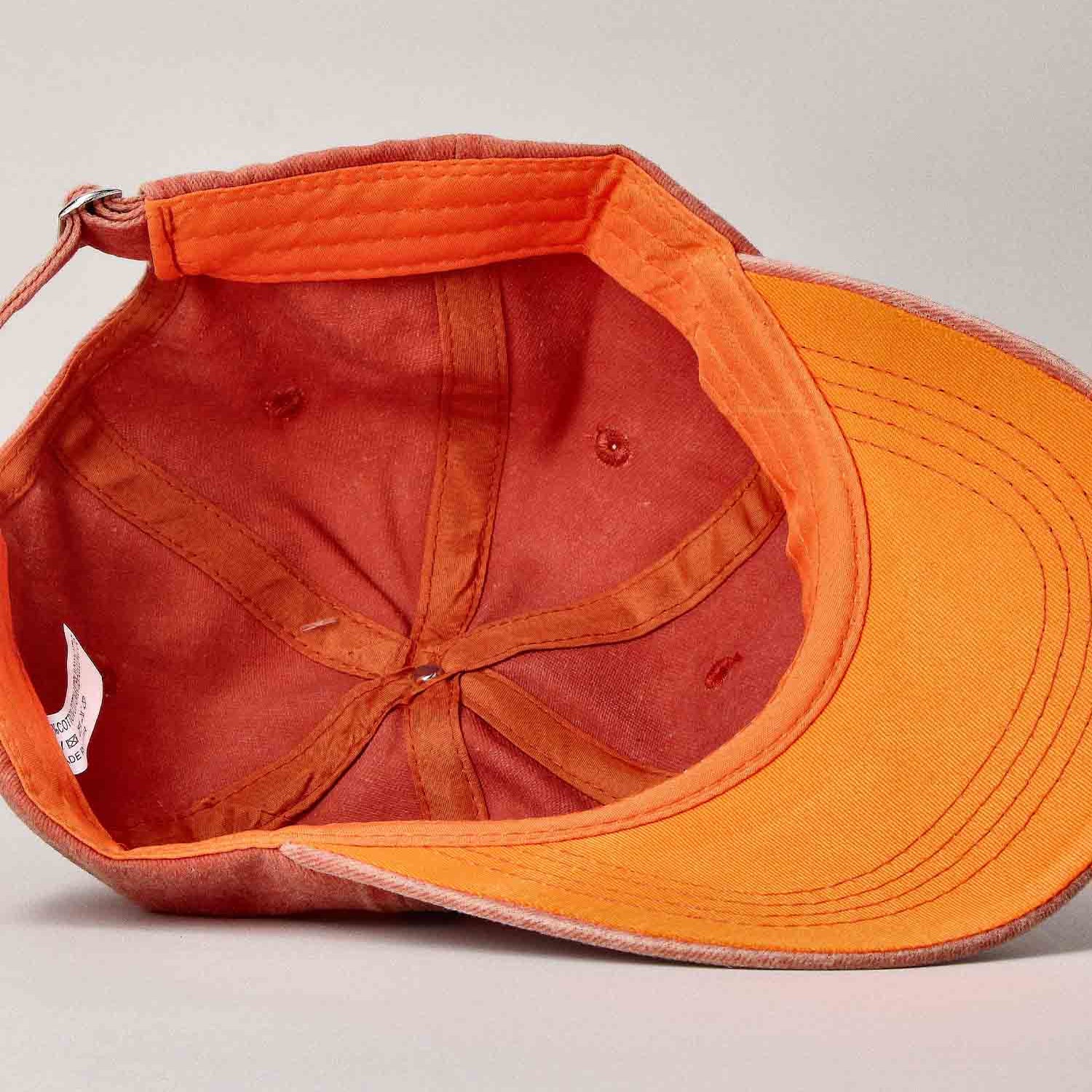 Orange baseball cap with a visible brand label on a light gray background