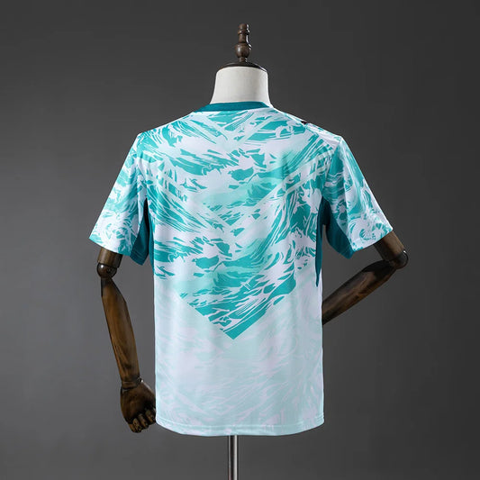 Teal and white patterned t-shirt on a mannequin against a gray background