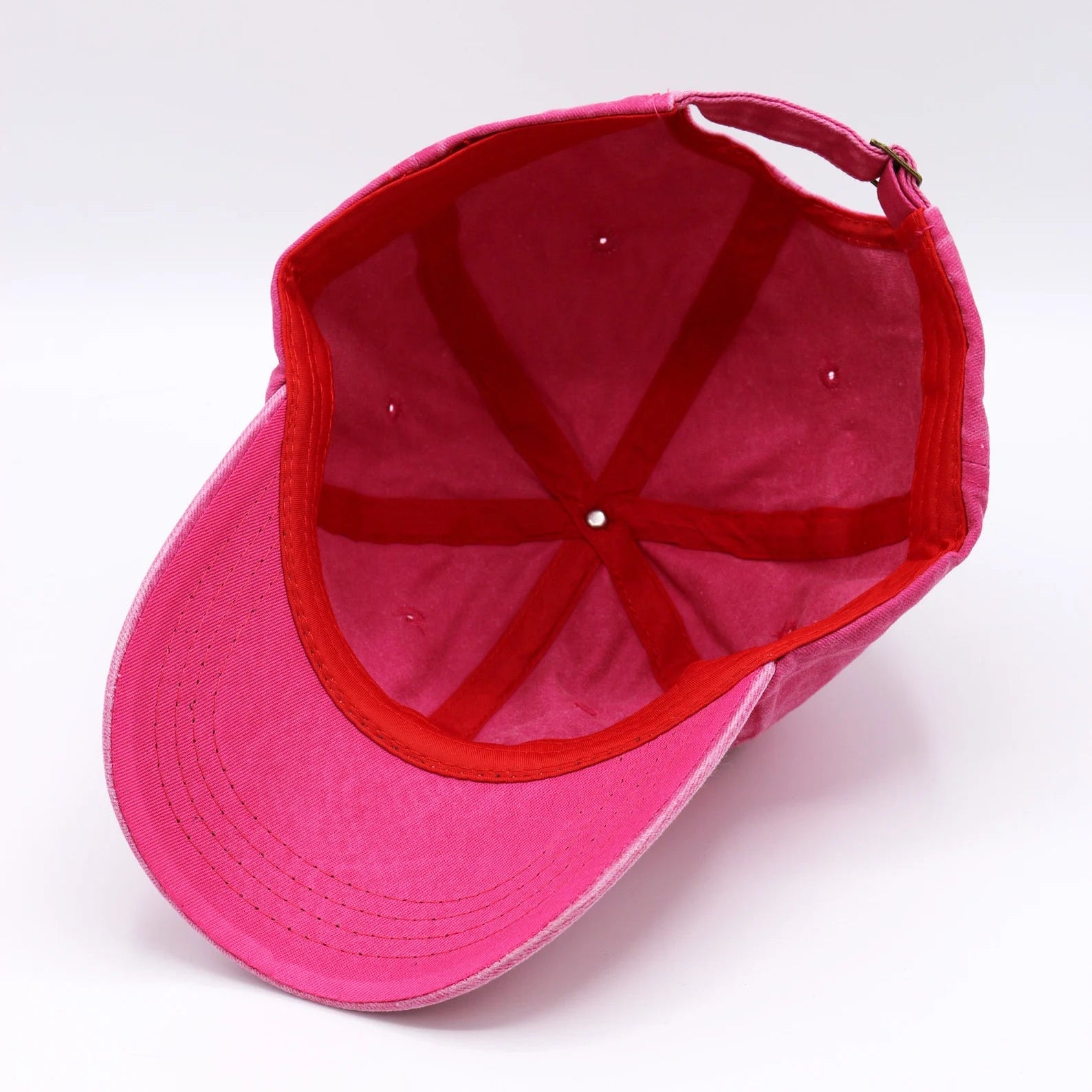 Pink cap with red interior on a white background