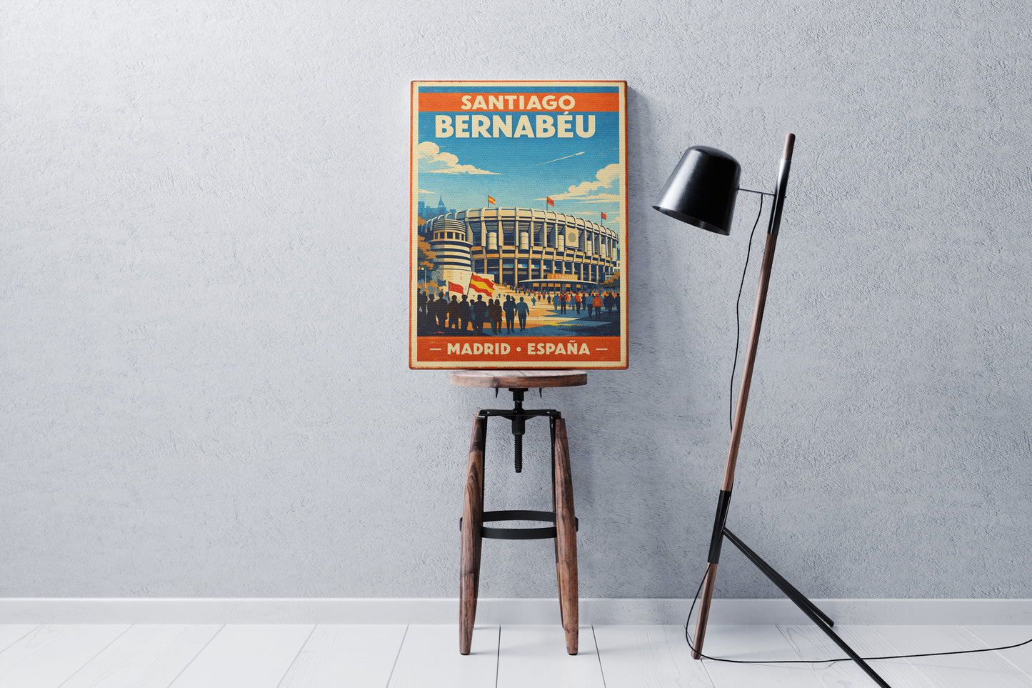 Poster of Santiago Bernabeu stadium on a stool against a gray wall with a floor lamp.
