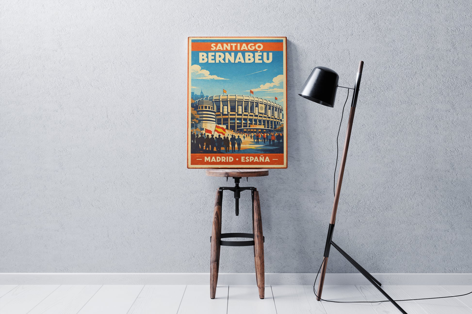 Poster of Santiago Bernabeu stadium on a stool against a gray wall with a floor lamp.