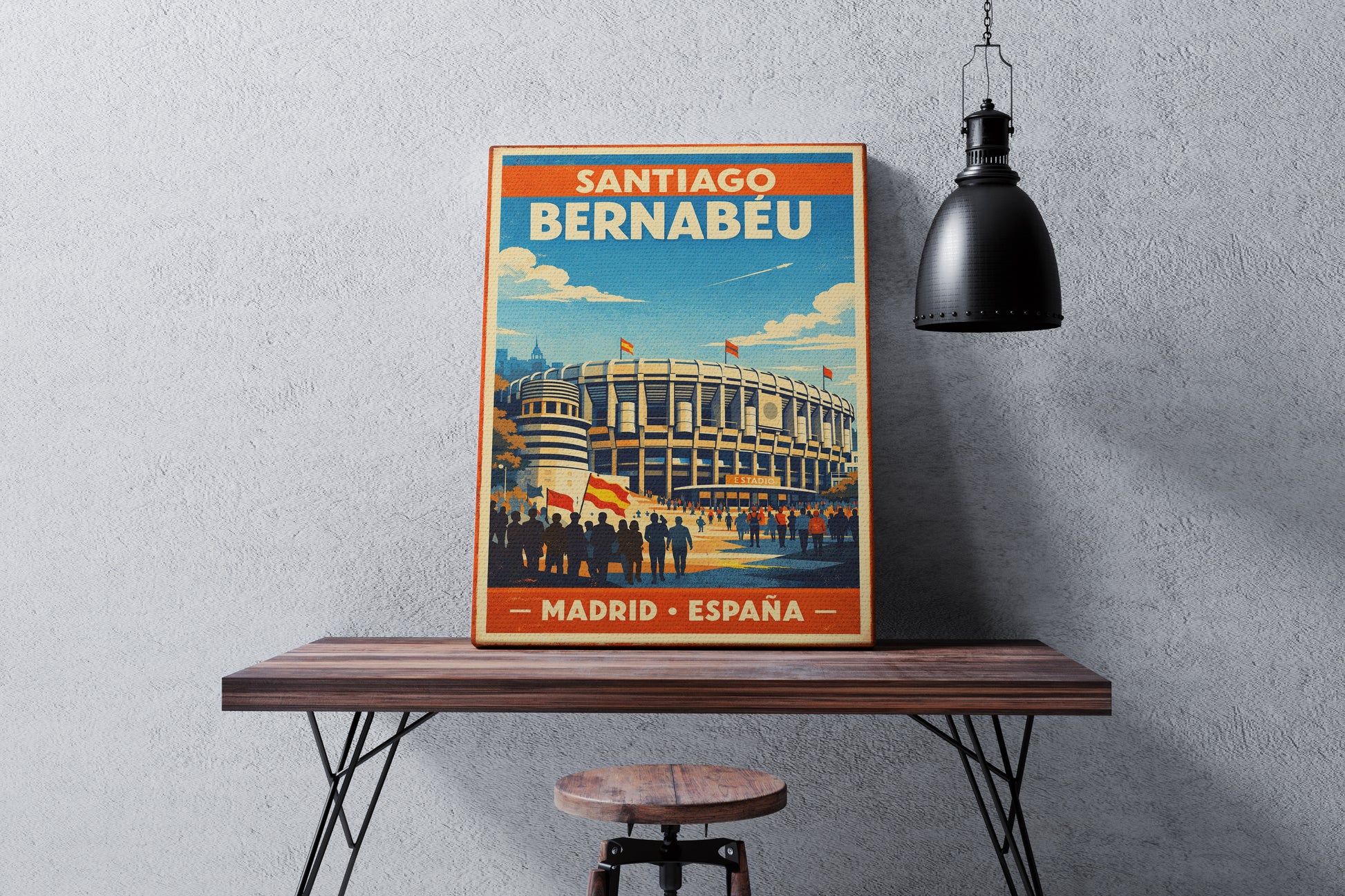Poster of Santiago Bernabéu stadium on a wooden table against a gray wall.