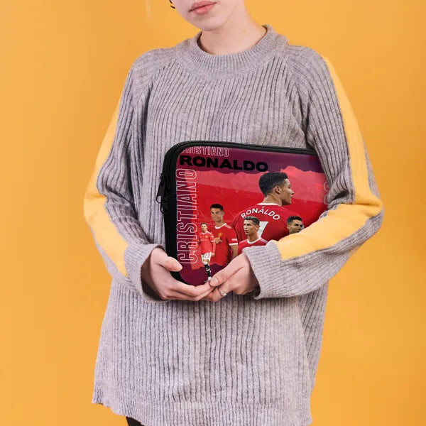 Person holding a bag with Cristiano Ronaldo images on a yellow background