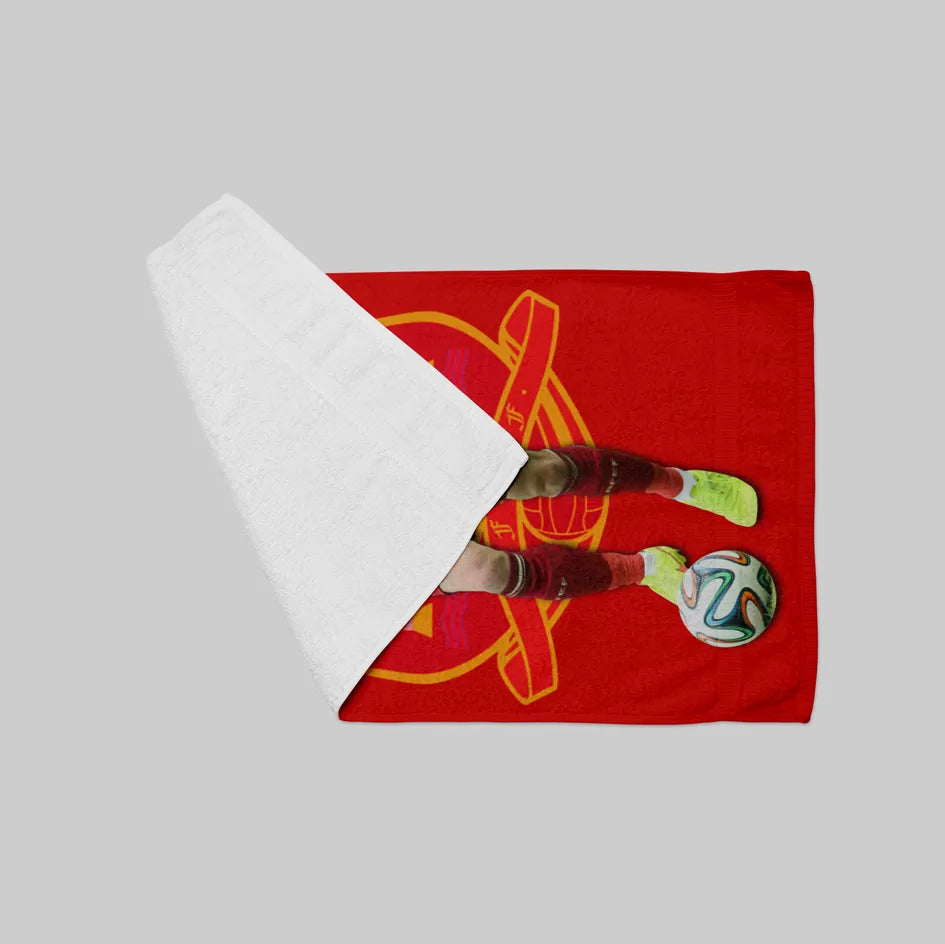 Red towel with sports graphics and a bottle on a gray background