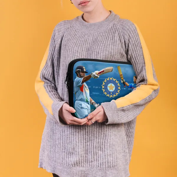 Person holding a laptop case with cricket design against a yellow background