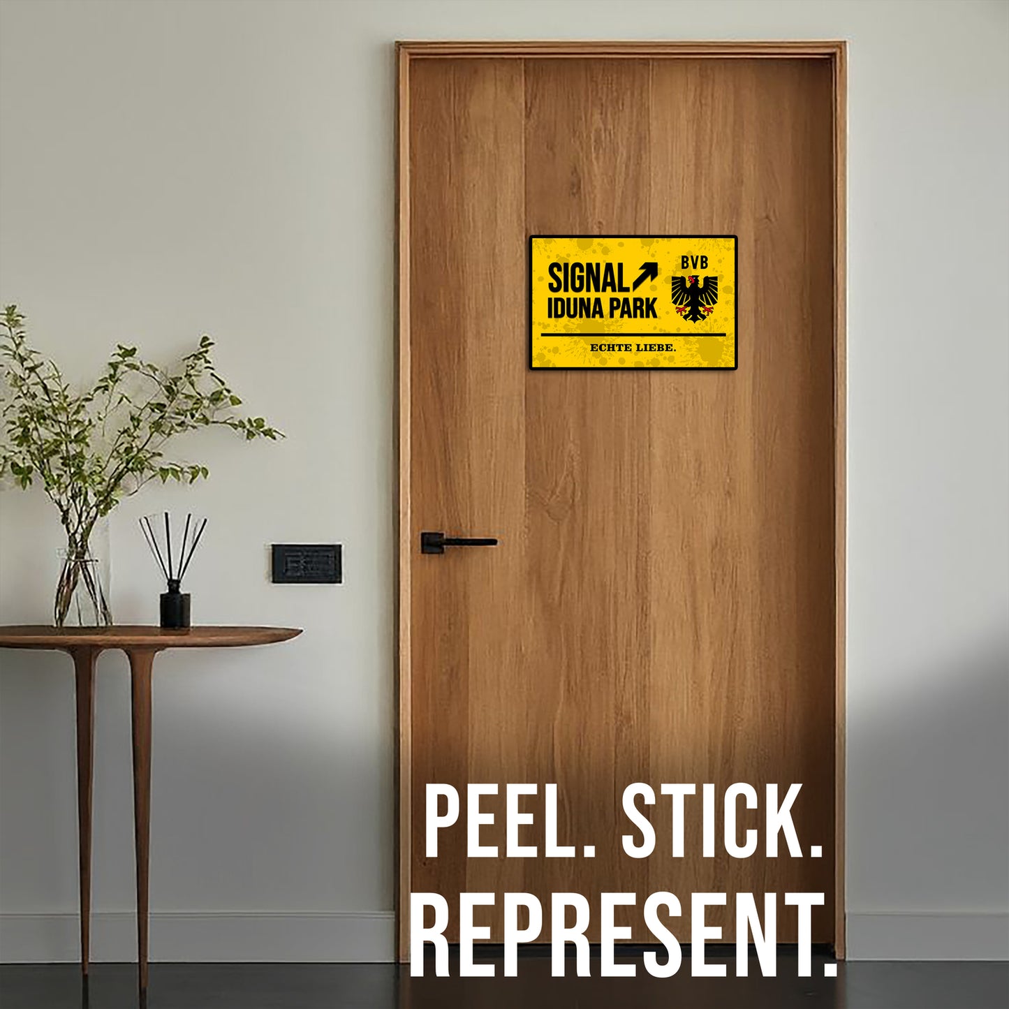 Wooden door with a yellow sign and text 'Peel. Stick. Represent.'