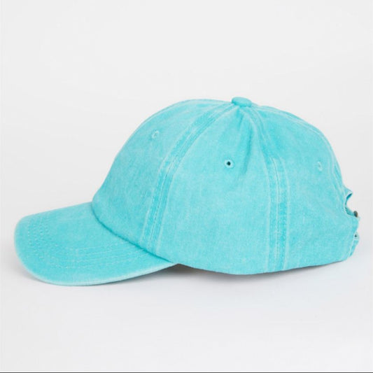 Turquoise baseball cap on a light gray background