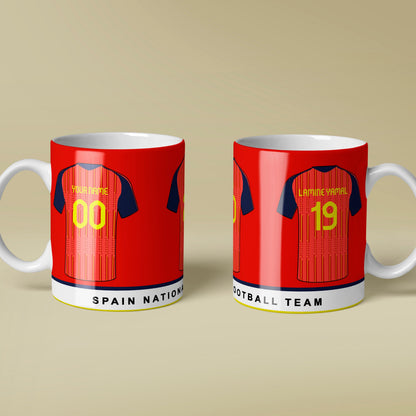 Two red mugs with white handles featuring Spain football team designs on a beige background