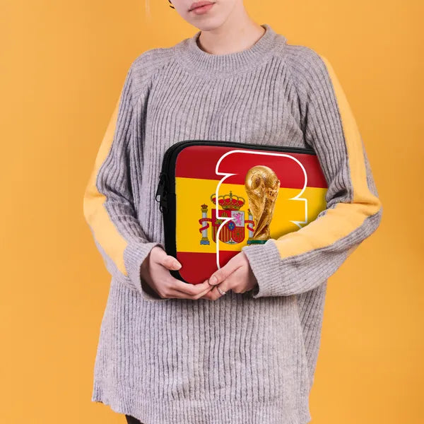 Person holding a pouch with a design of a trophy and Spanish flag on an orange background