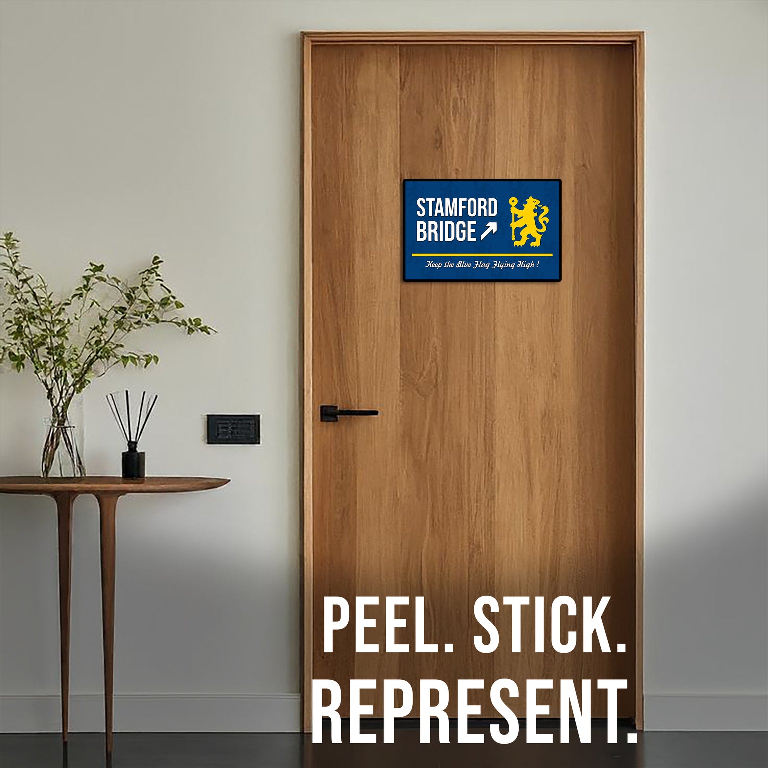 Wooden door with a Stamford Bridge logo sticker and text 'Peel. Stick. Represent.'