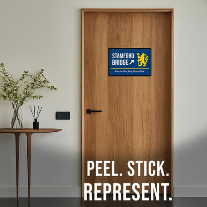 Wooden door with a Stamford Bridge logo sticker and text 'Peel. Stick. Represent.'
