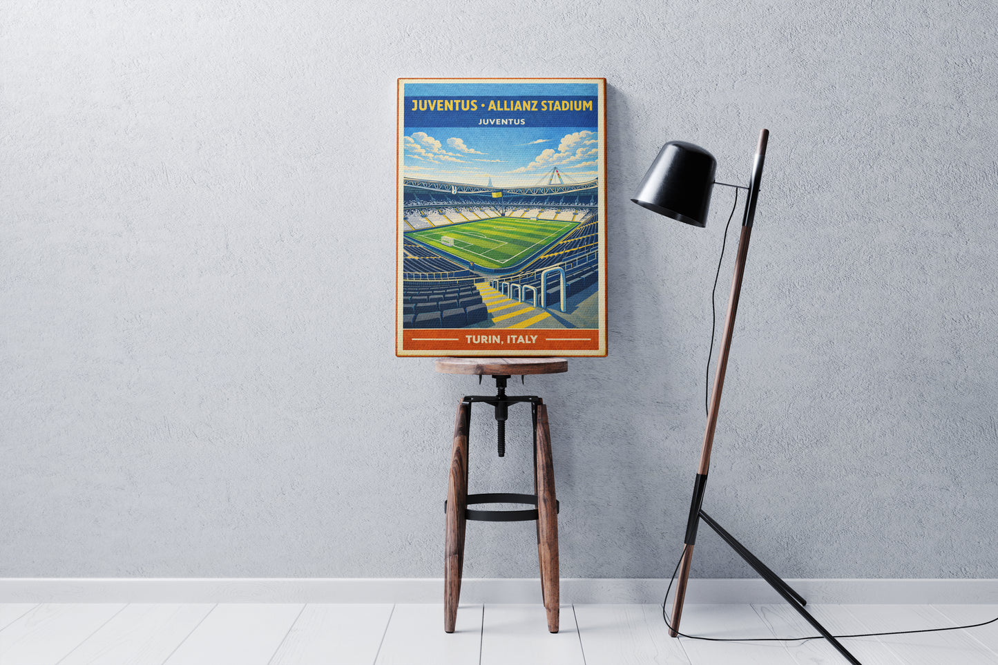 Vintage-style poster of Juventus' Allianz Stadium on a stool against a gray wall.