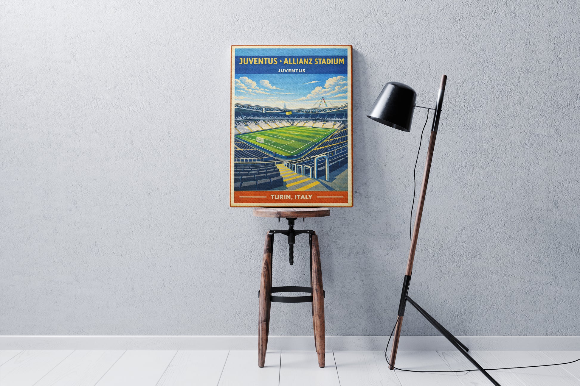 Vintage-style poster of Juventus' Allianz Stadium on a stool against a gray wall.
