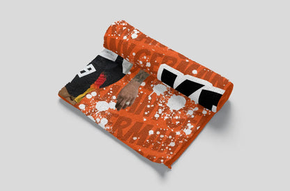 Orange pillow with black and white design on a gray background
