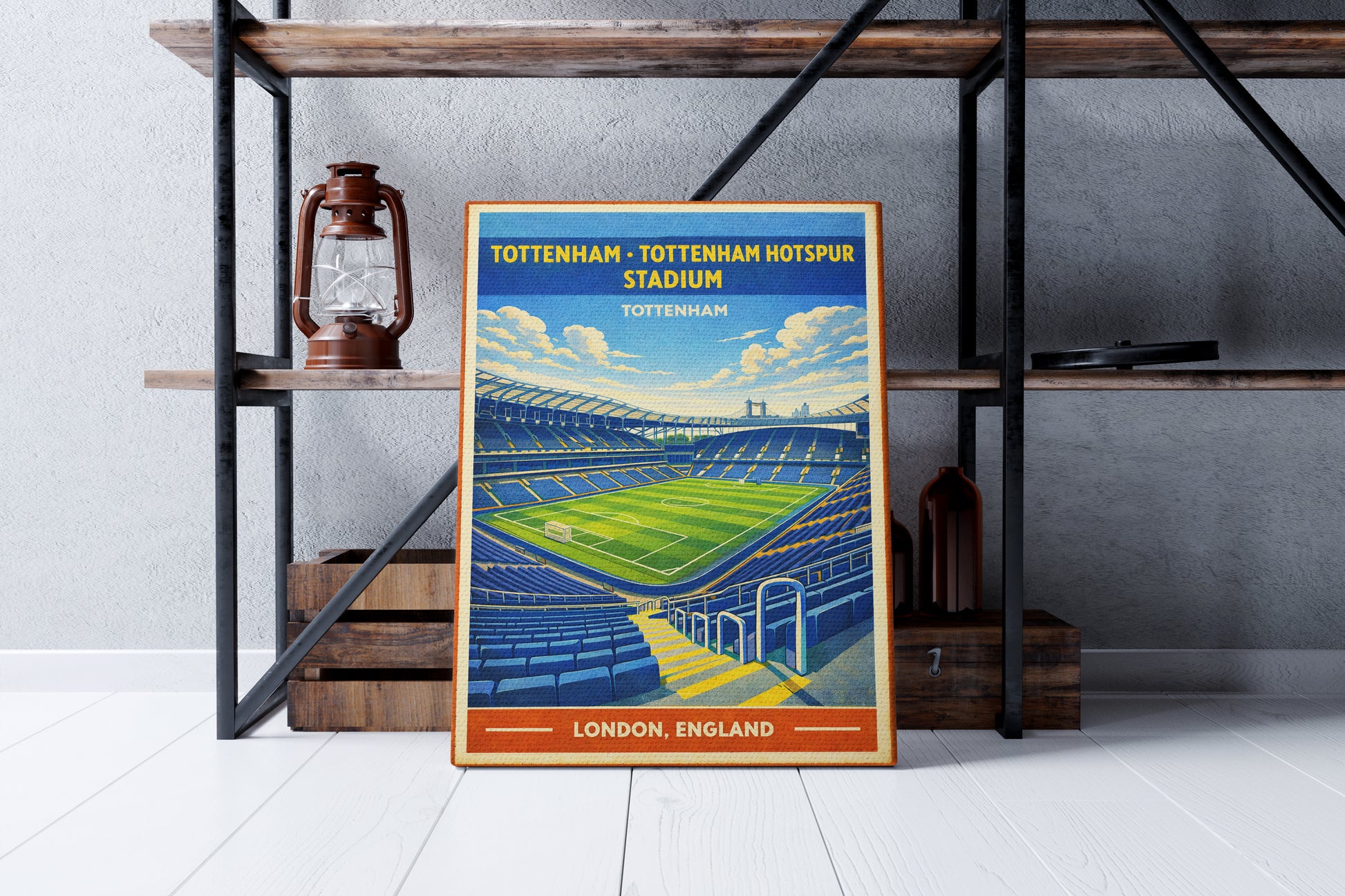 Framed poster of Tottenham Hotspur Stadium in a room with a shelf and lantern.