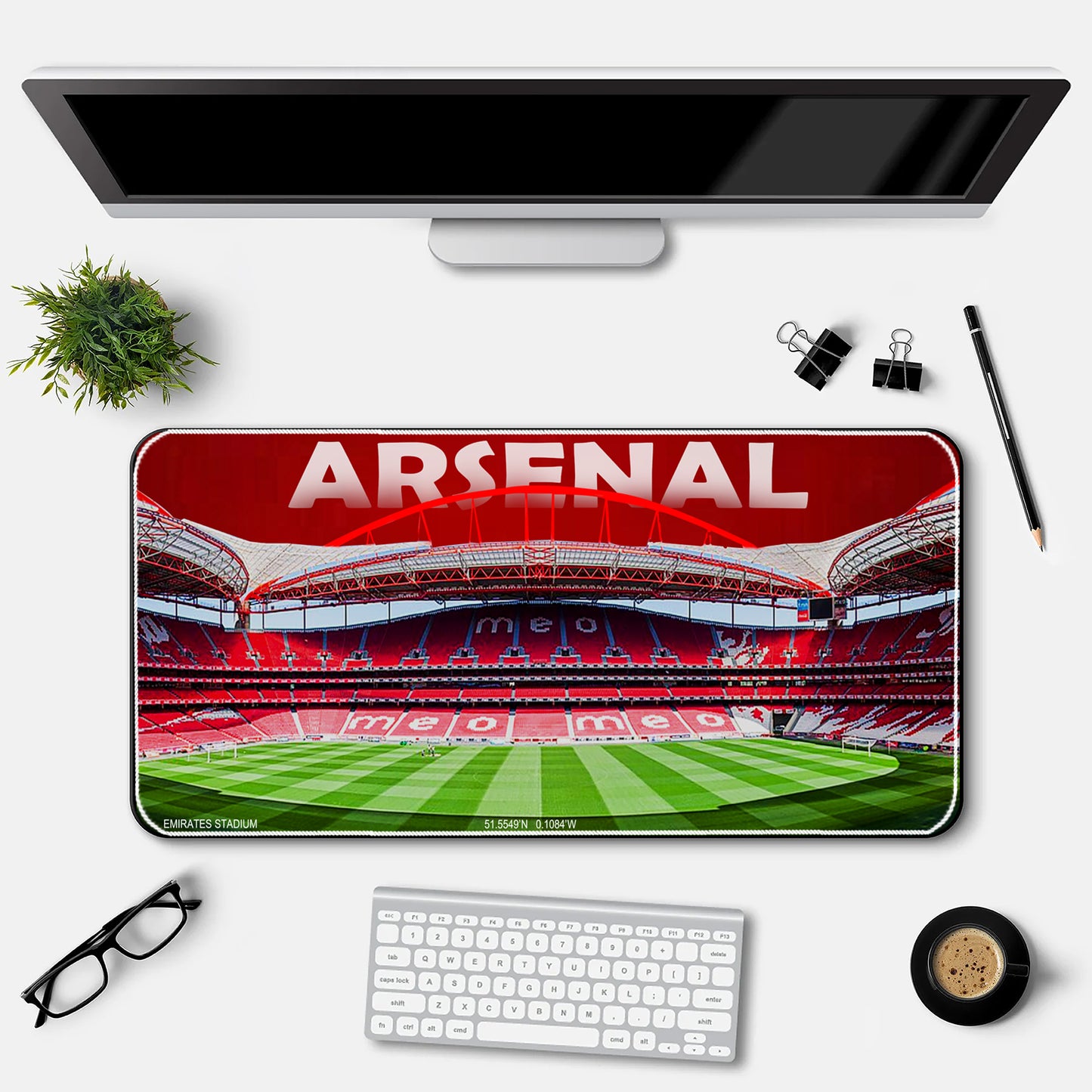 Desk setup with Arsenal-themed desk mat, monitor, keyboard, and stationery items.