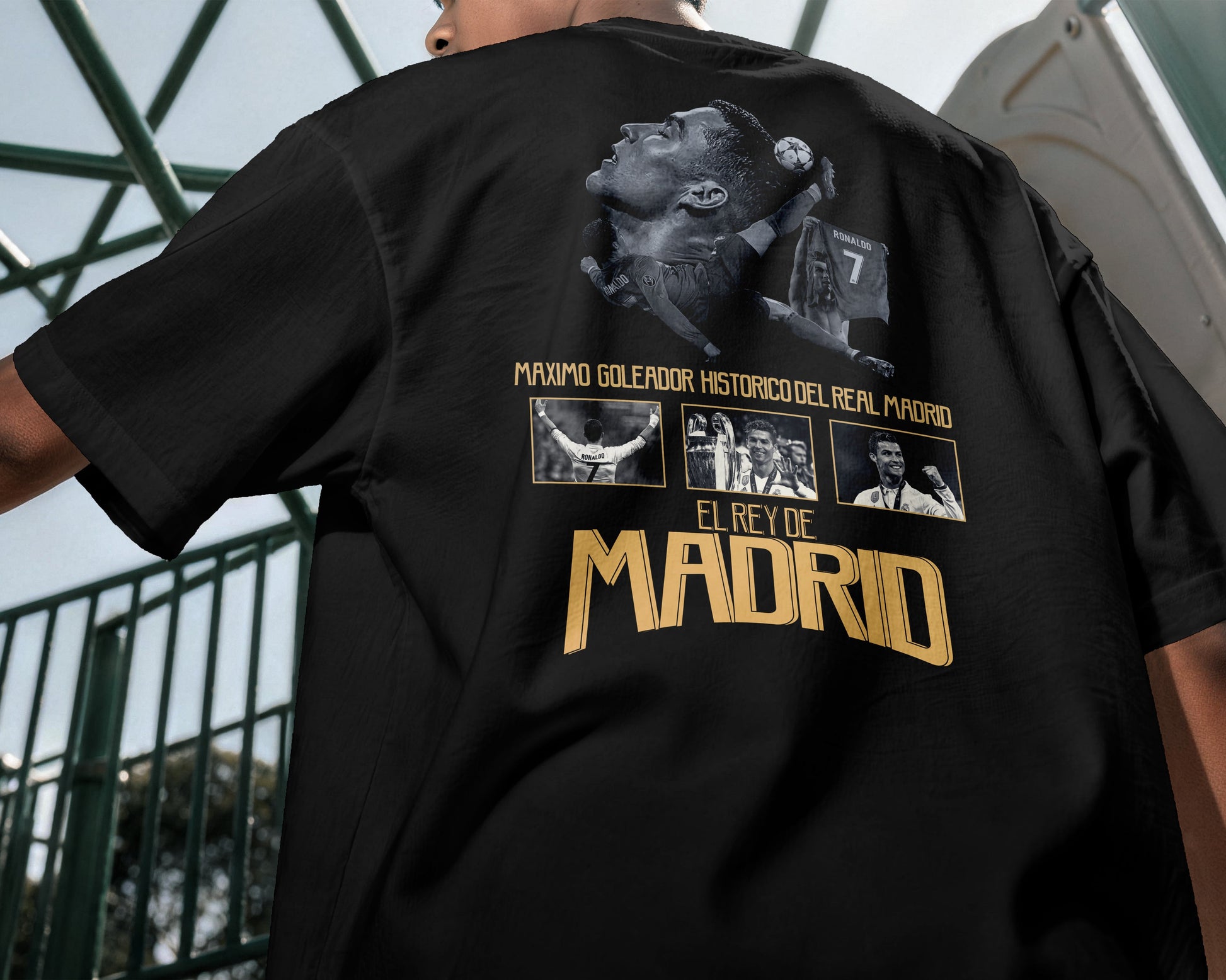 Black t-shirt with graphic design and text on the back, worn by a person.