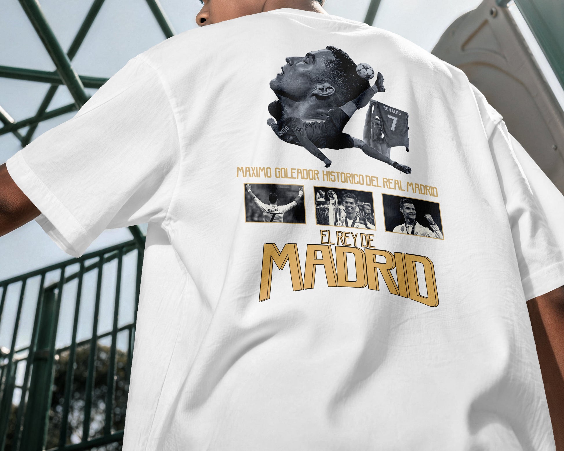 White t-shirt with graphic design and text on the back, worn by a person.