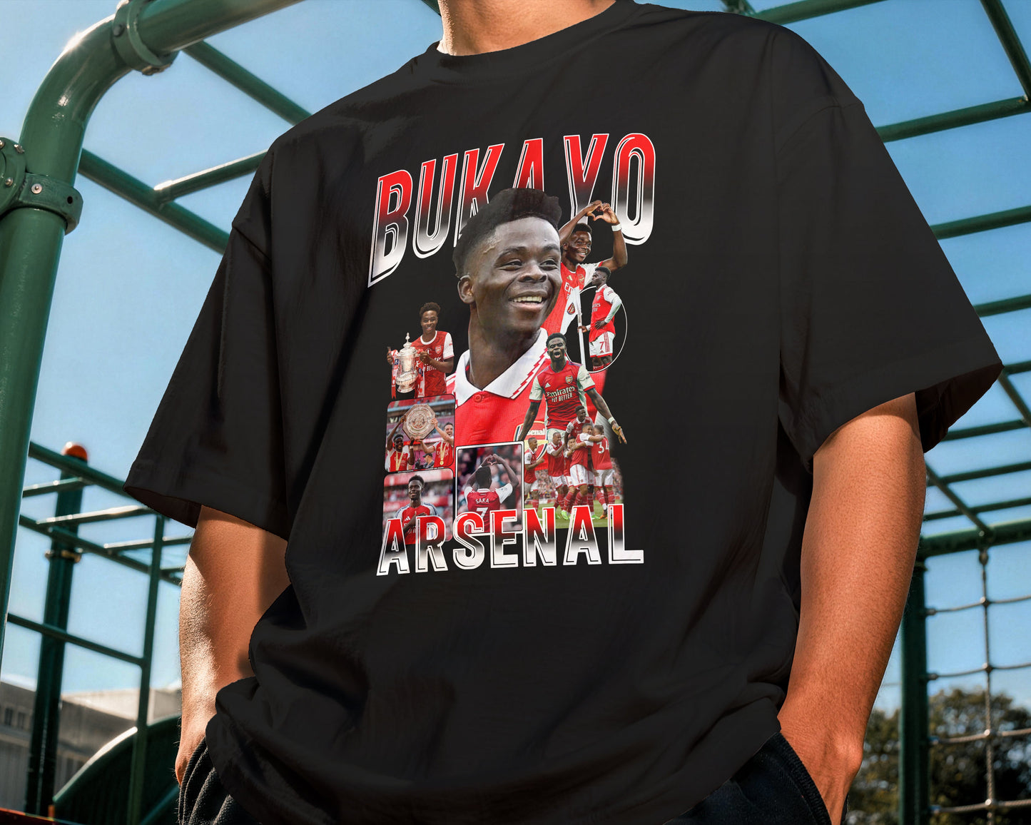 Person wearing a black t-shirt with 'Bukayo Arsenal' graphic design.